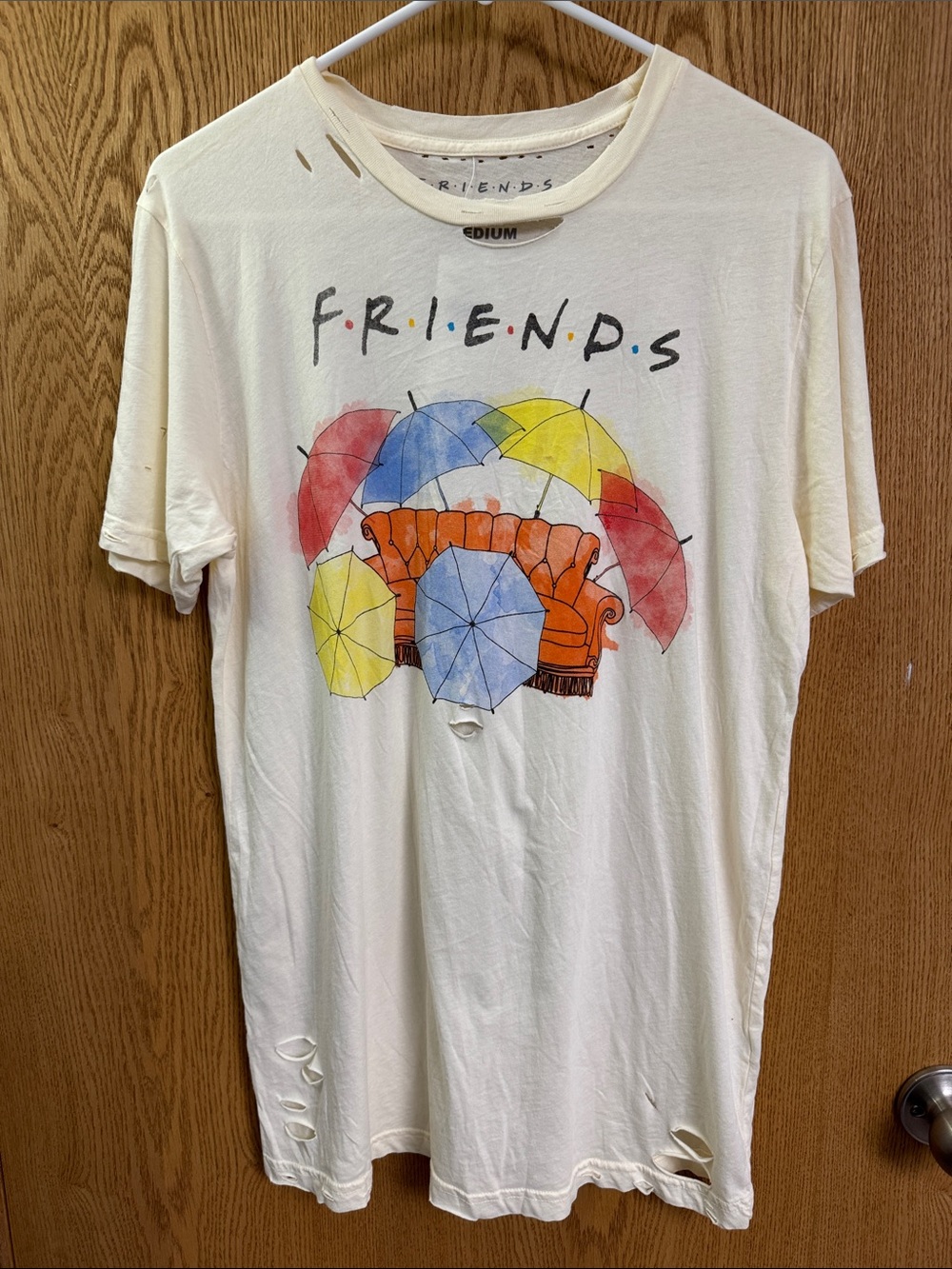 FRIENDS Cream Graphic Tee‎ with Orange Couch and Colorful Umbrellas